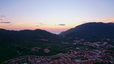 Aerial Drone view Sunset or sunrise mountain and road in kathu city Phuket thailand, Beautiful sunset sky, transportation footage background 4K Time lapse Transportation concept