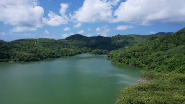 Aerial drone hyperlapse timelapse of beautiful valley between mountains lake.Amazing shadow clouds flowing over mountains lake. The rays of the sun hit the tree crowns beautiful nature landscape