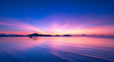 Landscape Long exposure of majestic clouds in the sky sunset or sunrise over sea with reflection in the tropical sea.Beautiful cloudscape scenery.Amazing light of nature Landscape nature background