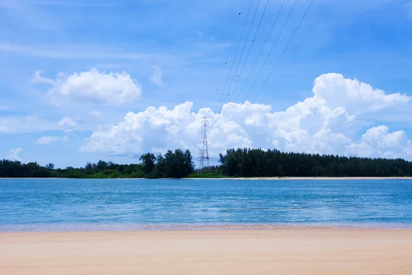 High voltage steel power pylons Transmission tower supporting high voltage power line Tower of power lines in the forest. Electric tower line over sea Landscape nature view