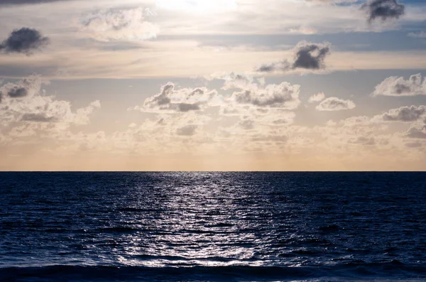 Sunset at the open sea, Horizontal photo with natural sunset or sunrise light and darkness sea waves background