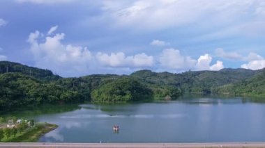 Aerial drone hyperlapse timelapse of beautiful valley between mountains lake.Amazing shadow clouds flowing over mountains lake. The rays of the sun hit the tree crowns beautiful nature landscape