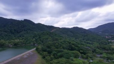 Aerial drone hyperlapse timelapse of beautiful valley between mountains lake.Amazing shadow clouds flowing over mountains lake. The rays of the sun hit the tree crowns beautiful nature landscape