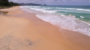 Top view tropical beach Amazing waves sea background. Crashing waves on beach sand, Beautiful sea background