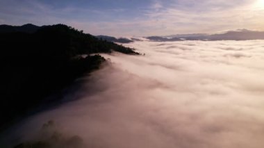 High angle view drone view of fog in rainy season over mountains,Beautiful sunrise sky clouds for create nature video scene. 4K High quality footage