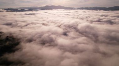High angle view drone view of fog in rainy season over mountains,Beautiful sunrise sky clouds for create nature video scene. 4K High quality footage