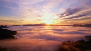 High angle view drone view of fog in rainy season over mountains,Beautiful sunrise sky clouds for create nature video scene. 4K High quality footage