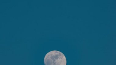 Full moon is moving across light clear blue sky background Time Lapse,Amazing moon High quality footage Timelapse 60FPS.