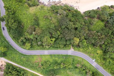 Aerial view Curve Road in the forest green summer trees Drone camera top down view Amazing landscape High angle view Green background