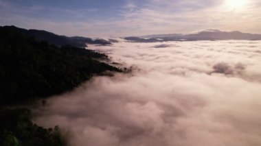 High angle view drone view of fog in rainy season over mountains,Beautiful sunrise sky clouds for create nature video scene. 4K High quality footage