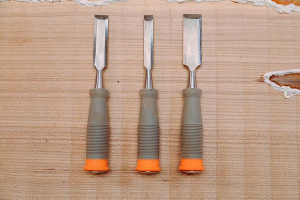 Set of chisels on wooden table. Tools for wood work