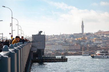 Istanbul, Turkey - December 17, 2018: People fishing on the Galata bridge in Istanbul