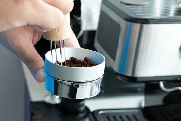 hand mash coffee bean in coffee grinder