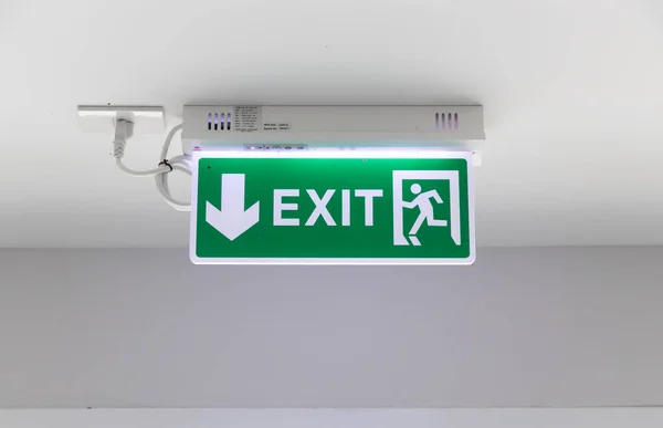 Fire exit signs installed on the wall of the building.
