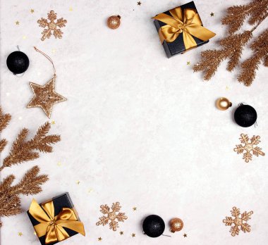 Açık mermer arka planda siyah ve altın süslemelerden bir Noel çerçevesi. Boşluğu kopyala, üst görünüm.