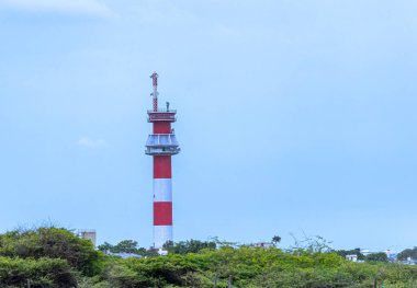 A Lighthouse near a sea beach red and white