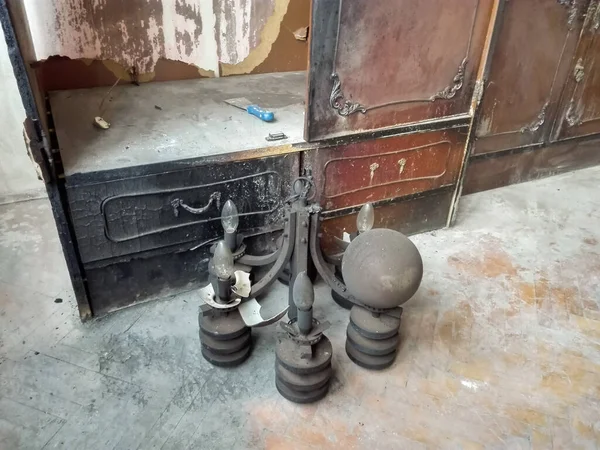 Broken chandelier on the floor of living room. Old and dusty fallen chandelier. Closeup look of the broken chandelier.