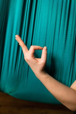 Training on a hammock with a beautiful girl. Fly yoga in the gym. Aero yoga.