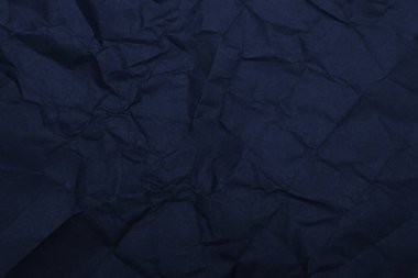 Koyu mavi buruşuk kağıt arka plan oluşturuyor..
