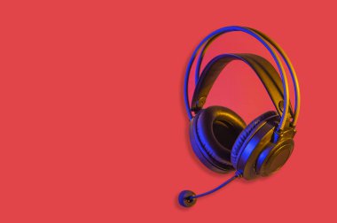 Kırmızı pankarttaki siyah kulaklık müşteri hizmetleri kavramını gösteriyor.