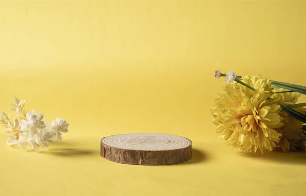 Natural flowers and wooden piece with copy space for natural product mockup.