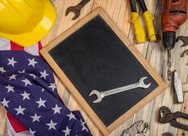Screwdriver on blackboard with copy space and USA flag - labor day conceptual banner.