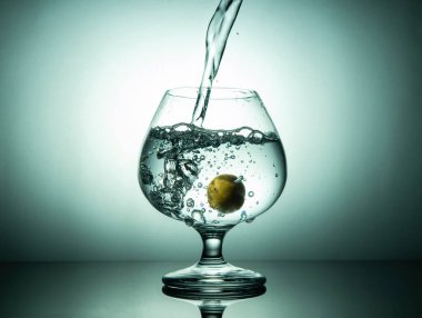 Taze içme suyu limonlu bardağa dökülüyor, sağlıklı yaşam tarzı konsepti..