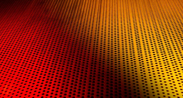 金属板を通過する赤と黄色のLedが抽象的な背景を作ります — ストック写真