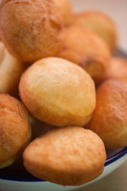 Traditional Kazakh Asian baursak dish prepared with dough on a pan with oil, selective focus, vertical
