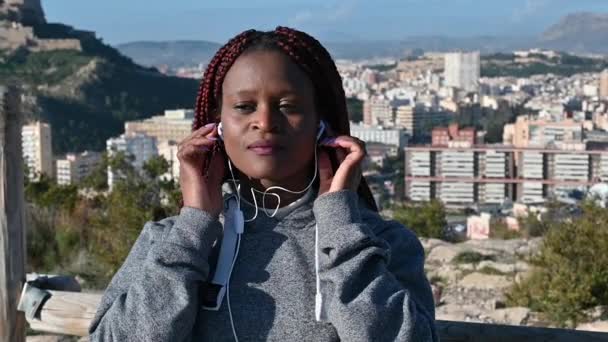 Afričanka s dredy tančí proti horám a městu — Stock video