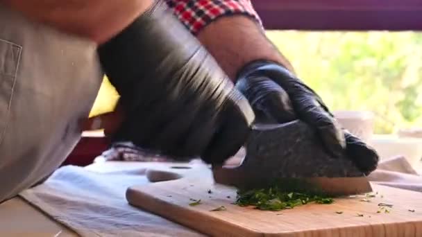 Chef hakt verse peterselie met een mes — Stockvideo
