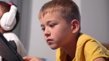 Çocuk tablette video oyunları oynuyor. 