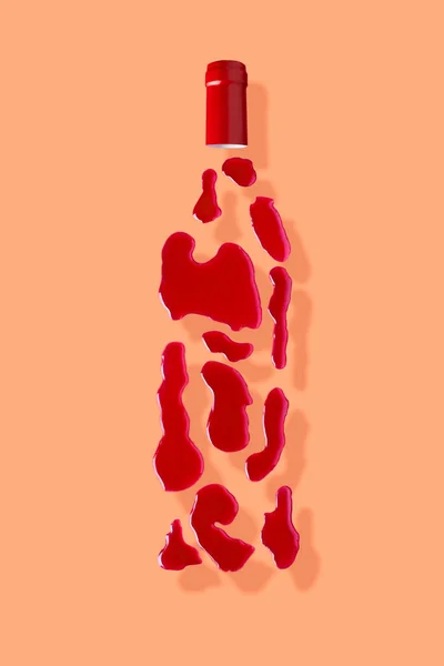 Bottle of red wine on beige background — стоковое фото