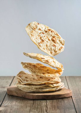 Indian chapati flatbread, creative photography with levitation. High quality photo clipart