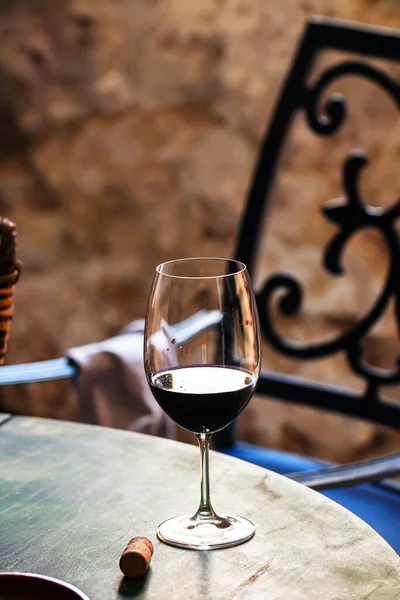 A glass of red wine on a table in an old house. High quality photo