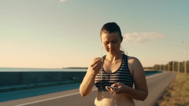 Portrait Pretty Girl Wearing Headphones Listening Music Walks Road Sunset — Stockvideo