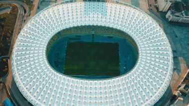 UKRAINE, KYIV - 12 April 2020: National Sports Complex Olympiyskiy. Flying over an empty football stadium inside a sorting complex. Empty stands, no game. High quality 4k footage