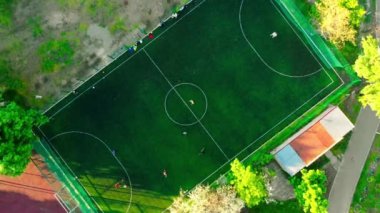 Aerial view of a football team training in the afternoon on a soccer field at sunset. Football match.Healthy lifestyle. High quality 4k footage.High quality 4k footage