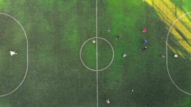 Scenic aerial view of a football field in the sun where children play.A small football field on the street in the city. High quality 4k footage