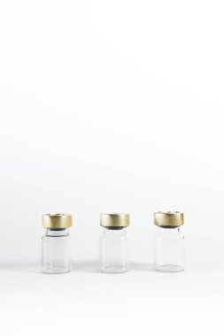 Three small empty glass vials on a white background. Medicine bottles. High quality photo