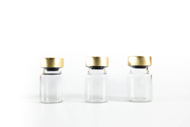Three small empty glass vials on a white background. Medicine bottles. High quality photo