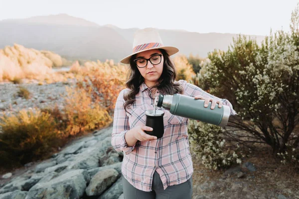 Young latin woman drinking yerba mate in a rural space Latin beverage. Ethnical concept. High quality photo. Horizontal. Copy space