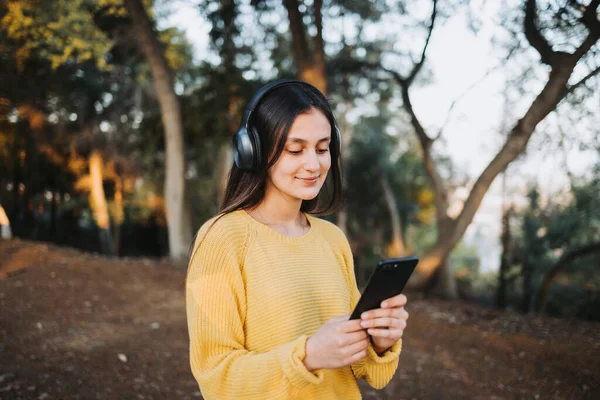 Adolescente Vistiendo Suéter Amarillo Usando Auriculares Para Reproducir Música Teléfono — Foto de Stock