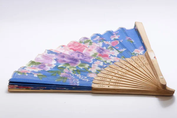 Traditional hand fan from Indonesia made of woven bamboo with floral motifs