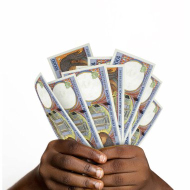 Black hands holding 3D rendered 10000 Central African Cfa franc notes. closeup of Hands holding Cfa franc currency