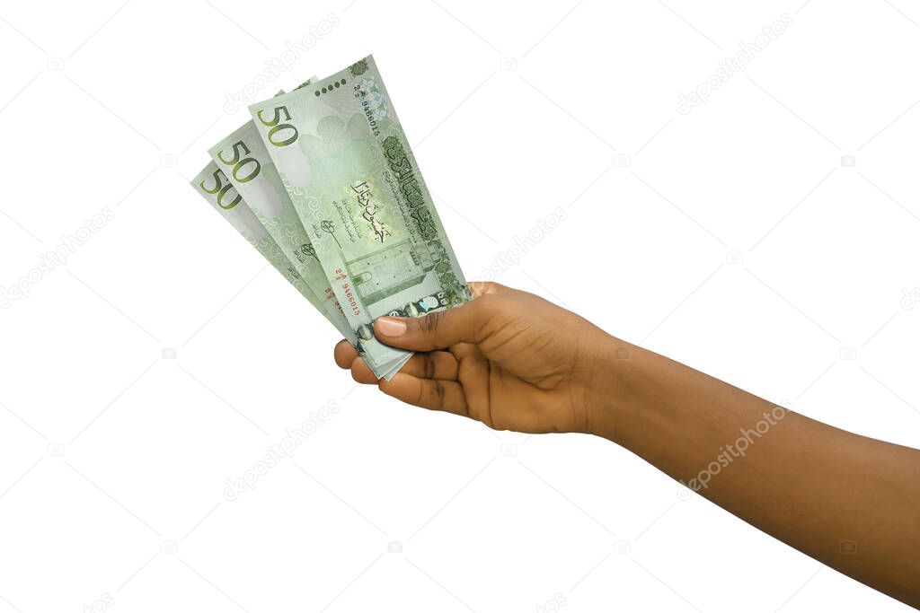 Fair hand holding 3D rendered Libyan Dinar notes isolated on white background