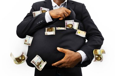 Black Businessman holding black bag full of Nigerian naira notes isolated on white background, money falling from bag