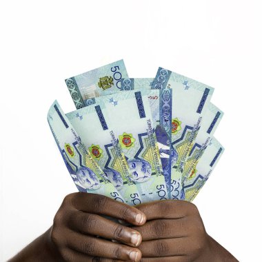 Black hands holding 3D rendered Turkmenistani manat notes. closeup of Hands holding Turkmenistan currency notes