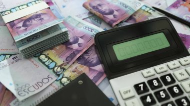 Cape Verdean escudo notes spread out with a calculator, pen and notebook. 3d rendering