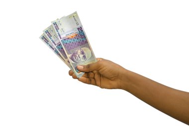 Fair hand holding 3D rendered Cape Verdean escudo notes isolated on white background